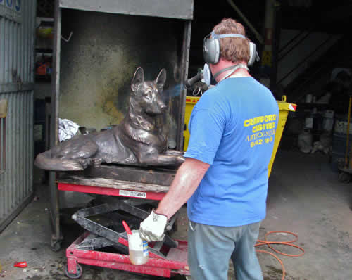 K9 Memorial - patina being applied to bronze dog